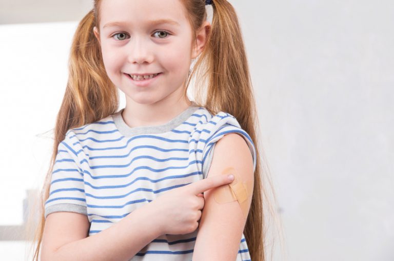 Girl with bandage over immunization